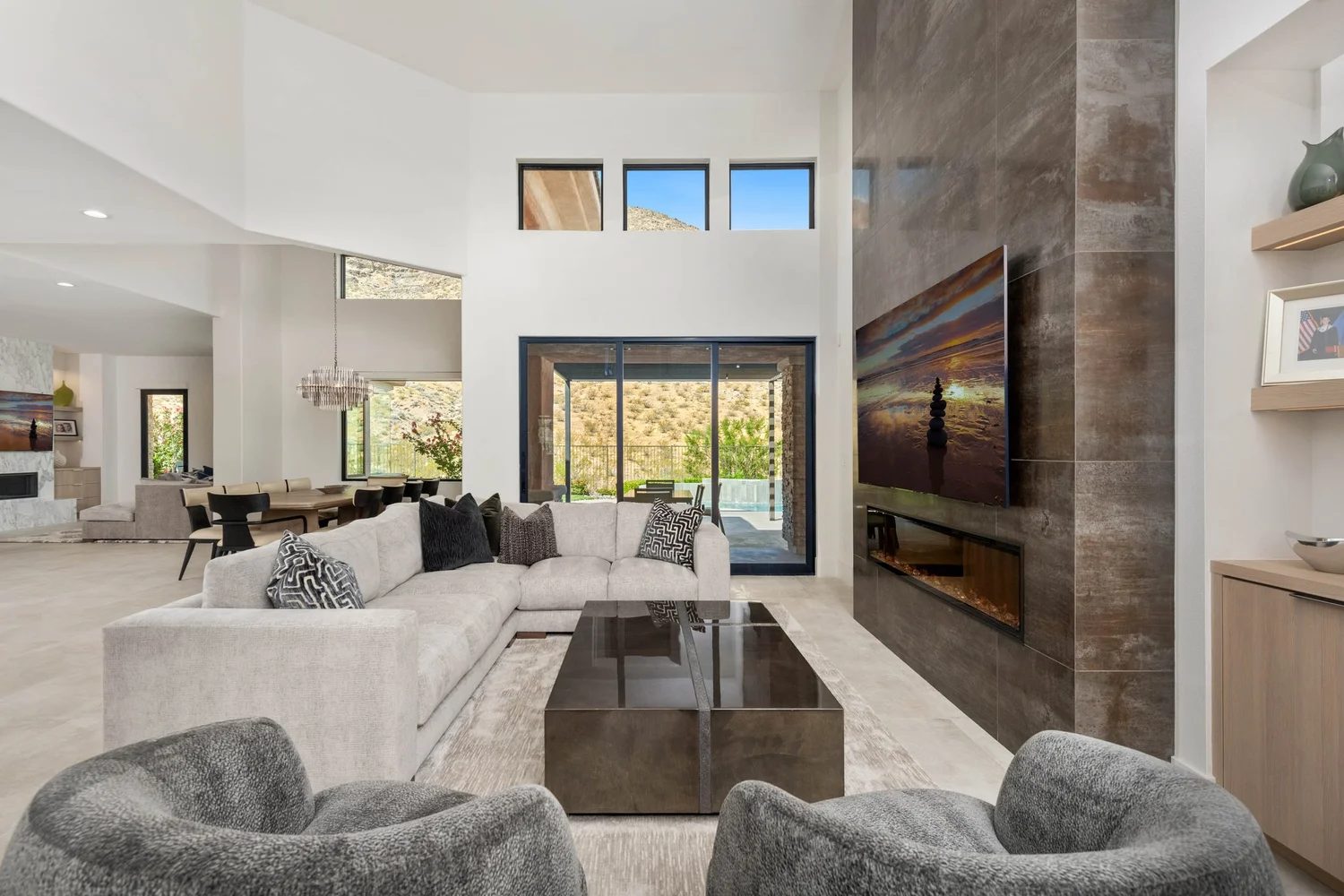 Red Rock Foothills great room — two-story fireplace wall and mountain views
