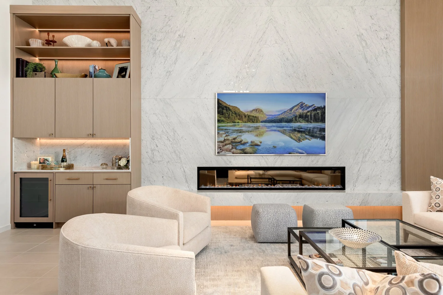 Mesa Abhaile great room — book-matched marble media wall, linear fireplace, and built-in bar