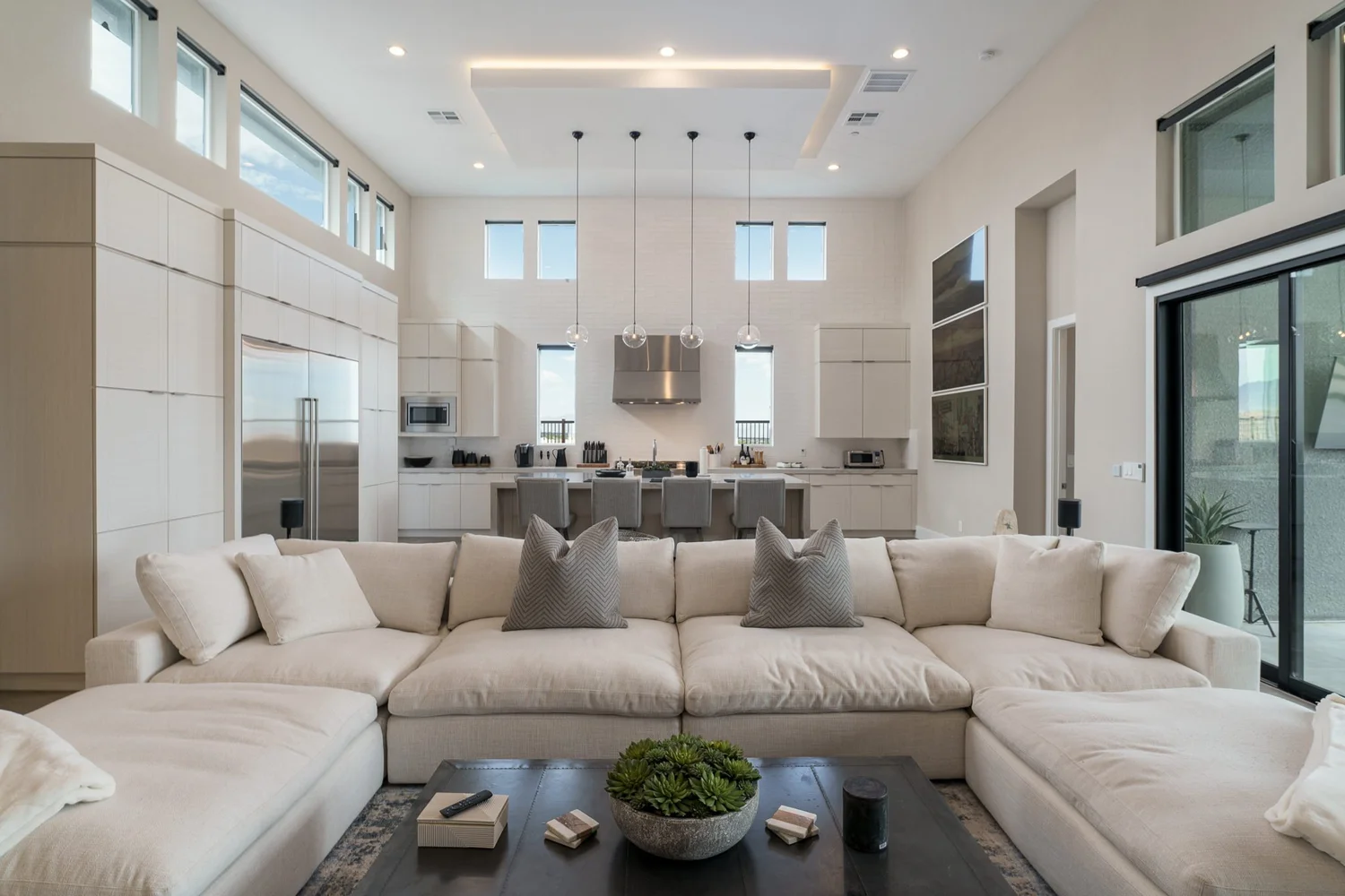 Steel Cloud great room — deep cream sectional beneath a lit recessed ceiling