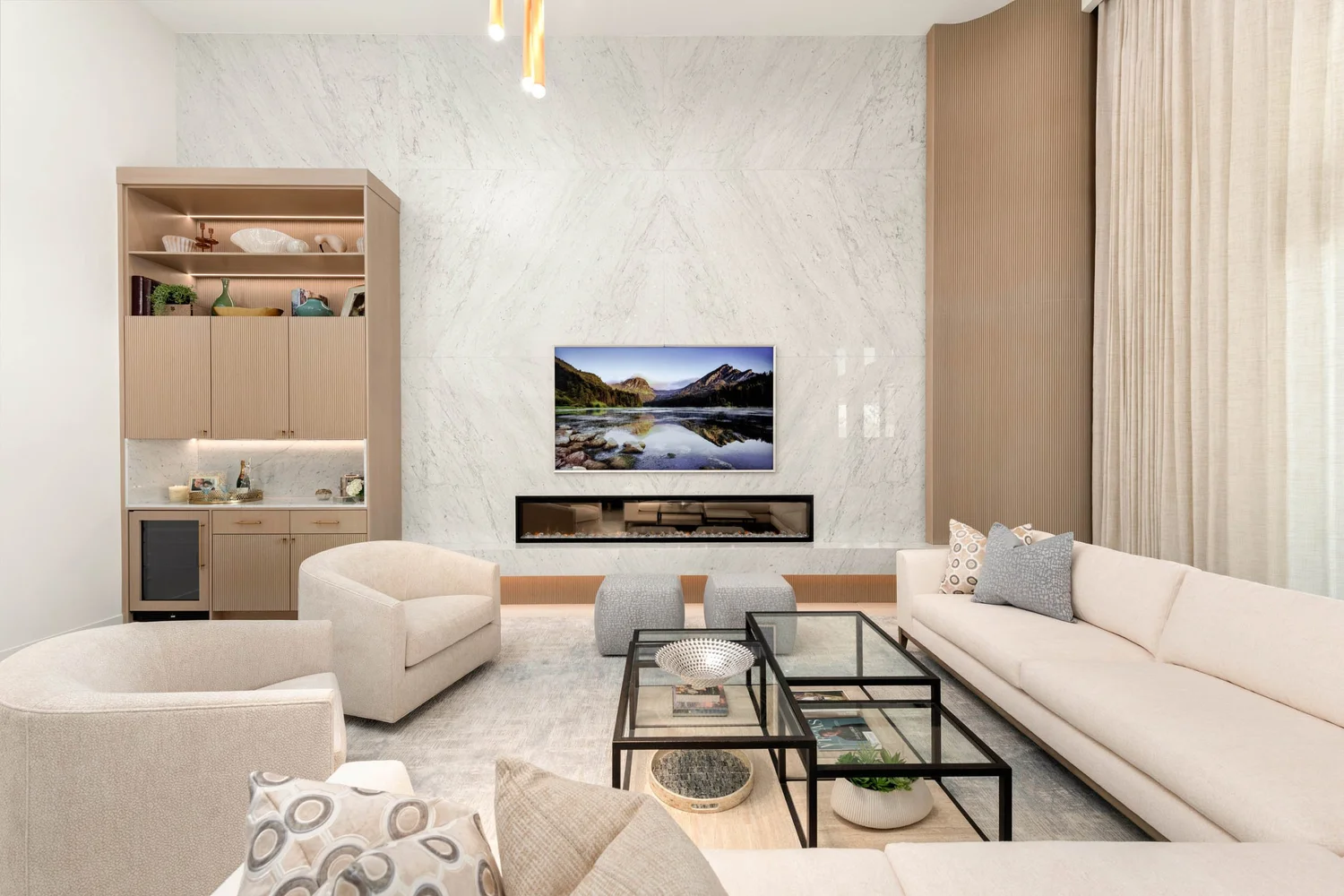 Mesa Abhaile great room seating — cream sofas around the marble wall